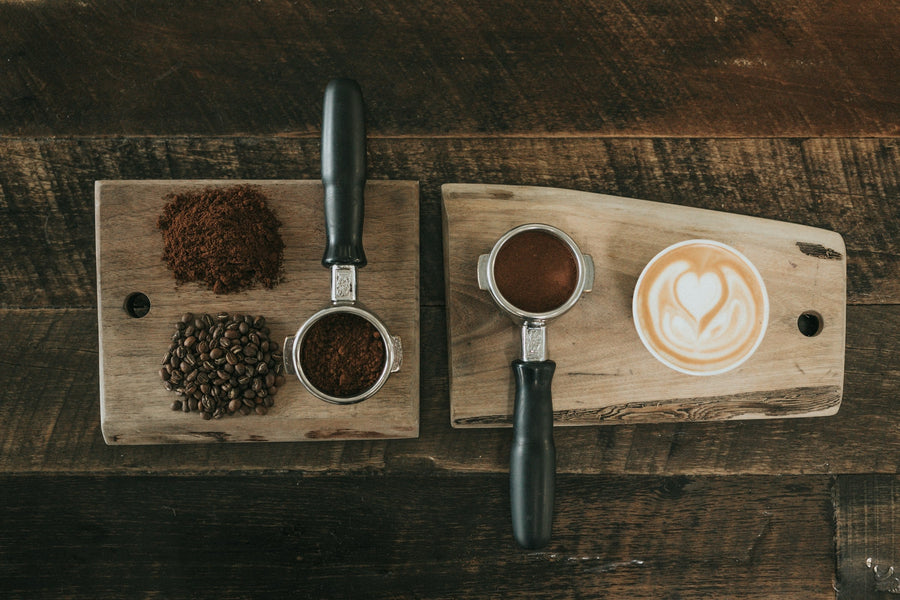 Coffee beans, ground coffee and espresso on a wooden tasting board