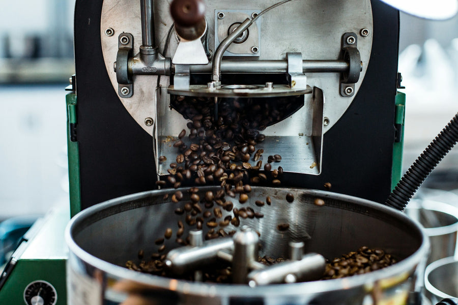 Freshly roasted coffee beans pouring from a roaster